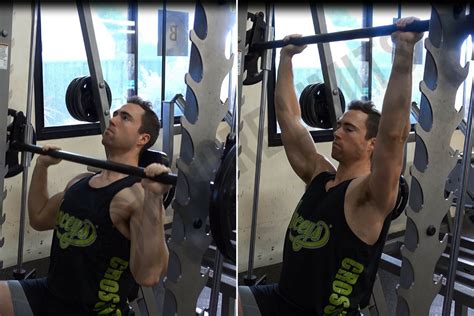 Smith machine shoulder press - Brace your core, bend your knees, and with control, drop your tailbone toward the floor as you lower into a squat. At the bottom of the squat position, aim for a 90-degree angle at the hips and knees. Exhale and press through the base of your foot as you squeeze your glutes to return to the starting position. Repeat.